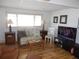 Living room with wood flooring, couch, coffee table, and large TV at 5232 Palena Blvd, North Port, FL 34287