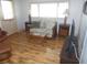 Living room with wood flooring, couch, coffee table, and large TV at 5232 Palena Blvd, North Port, FL 34287