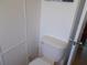 Clean bathroom with toilet and wood paneling at 5733 Holiday Park Blvd, North Port, FL 34287