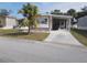 Mobile home exterior with carport and landscaped yard at 5733 Holiday Park Blvd, North Port, FL 34287