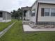Side view of mobile home showing steps and landscaping at 5733 Holiday Park Blvd, North Port, FL 34287
