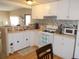 Kitchen features a breakfast bar and white cabinets at 5733 Holiday Park Blvd, North Port, FL 34287