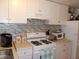 Well-equipped kitchen with white cabinets and modern appliances at 5733 Holiday Park Blvd, North Port, FL 34287