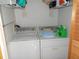 Laundry room with washer, dryer, and shelving at 5733 Holiday Park Blvd, North Port, FL 34287