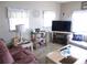Living room features a large TV and comfy seating at 5733 Holiday Park Blvd, North Port, FL 34287