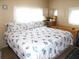Main bedroom with king-size bed and seashell bedding at 5733 Holiday Park Blvd, North Port, FL 34287