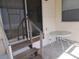 Small patio with table and access to the home at 5733 Holiday Park Blvd, North Port, FL 34287