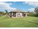 Large backyard with home view, providing ample space at 102 Linda Lee Dr, Rotonda West, FL 33947