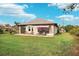Home's exterior with backyard view, showing patio and landscaping at 102 Linda Lee Dr, Rotonda West, FL 33947