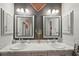 Double vanity bathroom with marble countertop and mirrors at 102 Linda Lee Dr, Rotonda West, FL 33947