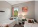 Two twin beds, a desk, and window with natural light at 102 Linda Lee Dr, Rotonda West, FL 33947