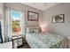 Bedroom with a full-size bed and a window at 102 Linda Lee Dr, Rotonda West, FL 33947