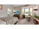 Main bedroom with a large bed and bay window at 102 Linda Lee Dr, Rotonda West, FL 33947