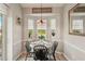 Charming breakfast nook with a round table and built-in window seating at 102 Linda Lee Dr, Rotonda West, FL 33947