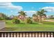 Landscaped front yard with tropical plants and a view of neighboring homes at 102 Linda Lee Dr, Rotonda West, FL 33947