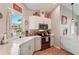 Modern kitchen with white cabinets, stainless steel appliances, and marble countertops at 102 Linda Lee Dr, Rotonda West, FL 33947