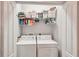 Convenient laundry room with washer, dryer, and ample storage shelves at 102 Linda Lee Dr, Rotonda West, FL 33947