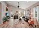 Spacious living area featuring hardwood floors, a cozy seating arrangement, and access to a patio at 102 Linda Lee Dr, Rotonda West, FL 33947