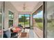 Cozy screened porch with seating and ceiling fan at 102 Linda Lee Dr, Rotonda West, FL 33947