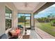 Relaxing screened porch with patio furniture, overlooking a lush green backyard at 102 Linda Lee Dr, Rotonda West, FL 33947