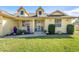 Front entrance with porch and landscaping at 1020 Caliva St, North Port, FL 34286