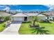 Single-story home with metal roof, palm tree, and driveway at 1029 San Mateo Dr, Punta Gorda, FL 33950