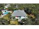 Aerial view of condo building, pool, and lush landscaping at 1051 Forrest Nelson Blvd # M-203, Port Charlotte, FL 33952