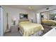 Bright bedroom with a yellow bedspread and mirrored closet at 1051 Forrest Nelson Blvd # M-203, Port Charlotte, FL 33952