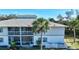 Condo building with screened porch and landscaping at 1051 Forrest Nelson Blvd # 203, Port Charlotte, FL 33952