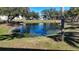 Tranquil pond surrounded by trees and grass at 1051 Forrest Nelson Blvd # M-203, Port Charlotte, FL 33952