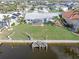 Aerial view of canal-front home with dock and yard at 1075 Messina Dr, Punta Gorda, FL 33950