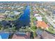 Aerial view showing a canal-front home with a pool and private dock at 1075 Messina Dr, Punta Gorda, FL 33950