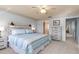 King-size bed, dresser, and access to bathroom at 1075 Messina Dr, Punta Gorda, FL 33950