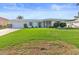 Ranch home with green lawn and screened porch at 1075 Messina Dr, Punta Gorda, FL 33950