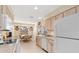 Kitchen with white appliances and light wood cabinets at 1075 Messina Dr, Punta Gorda, FL 33950