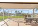 Relaxing screened patio with table and chairs, overlooking the canal at 1075 Messina Dr, Punta Gorda, FL 33950