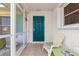 Relaxing screened porch with teal door and seating area at 1075 Messina Dr, Punta Gorda, FL 33950