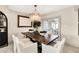 Bright dining room with a rustic wood table and modern chandelier at 1217 Spoonbill Dr, Punta Gorda, FL 33950