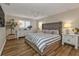 Serene main bedroom with plush bed and wood floors at 1217 Spoonbill Dr, Punta Gorda, FL 33950