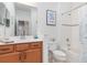 Clean bathroom with a tub, shower, and wood vanity at 1259 Backspin Dr, Englewood, FL 34223