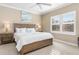 Main bedroom with king-size bed and neutral decor, featuring large windows at 1259 Backspin Dr, Englewood, FL 34223