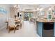 Bright dining room with wood table and six chairs, adjacent to kitchen and living room at 1259 Backspin Dr, Englewood, FL 34223