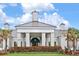 Elegant clubhouse exterior with columns and a manicured lawn at 1259 Backspin Dr, Englewood, FL 34223