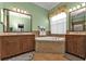 Spa-like bathroom featuring double sinks and a large mirror at 13147 Preserve Ct, Port Charlotte, FL 33953