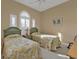 Guest bedroom with twin beds and arched window at 13147 Preserve Ct, Port Charlotte, FL 33953