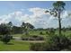 Landscaped golf course with pond and mature trees at 13147 Preserve Ct, Port Charlotte, FL 33953