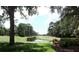 Serene golf course view with lush landscaping and water feature at 13147 Preserve Ct, Port Charlotte, FL 33953