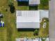 Aerial view of home showing roof, driveway, and surrounding landscape at 136 Seaward Way, North Port, FL 34287