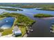 Aerial view of water view and houses near water access with docks for boating activities at 136 Seaward Way, North Port, FL 34287