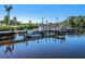 Scenic view of a private dock with boats, reflecting in the calm, clear water at 136 Seaward Way, North Port, FL 34287